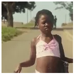 The bear stands on two legs and looks to the right.